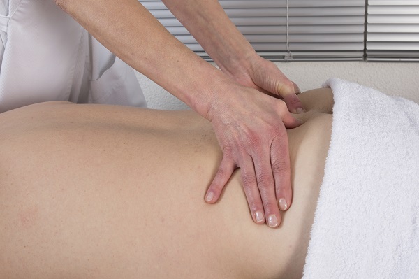 Image of a Masseuse giving a relaxing back massage at a spa